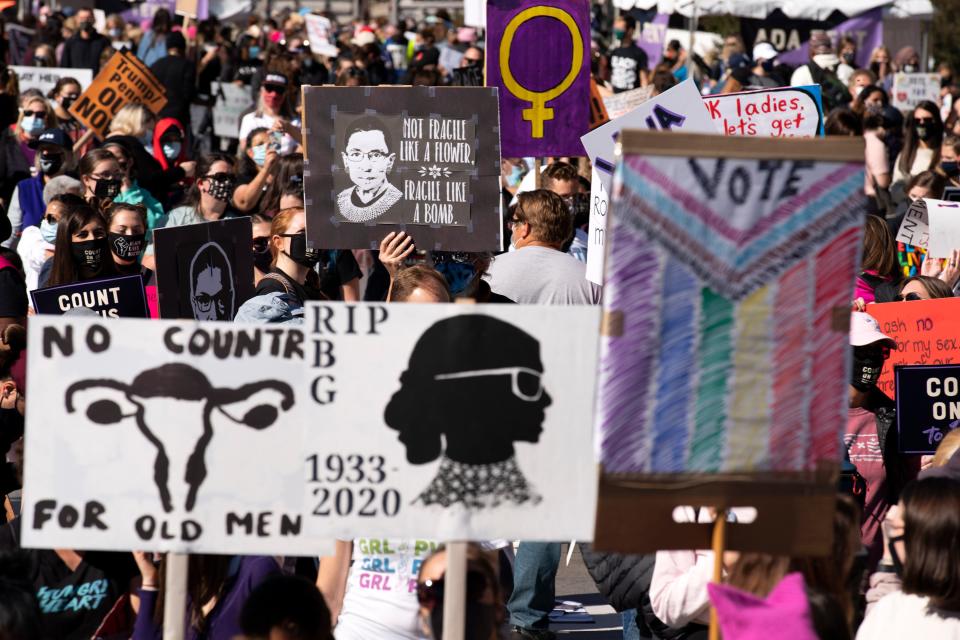 Demonstrators rally during the Women's March at Freedom Plaza, Saturday, Oct. 17, 2020, in Washington. (AP Photo/Jose Luis Magana)