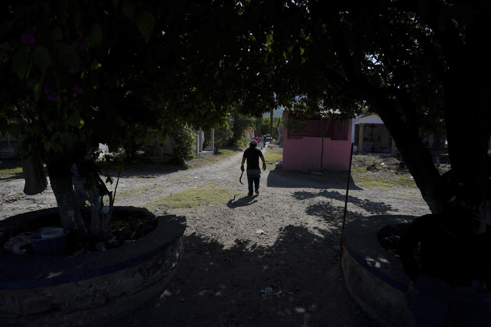 A volunteer joins the sixth National Search Brigade for missing people at a cemetery in Jojutla, Mexico, Monday, Oct. 11, 2021. The government's registry of Mexico’s missing has grown more than 20% in the past year and now approaches 100,000. (AP Photo/Fernando Llano)