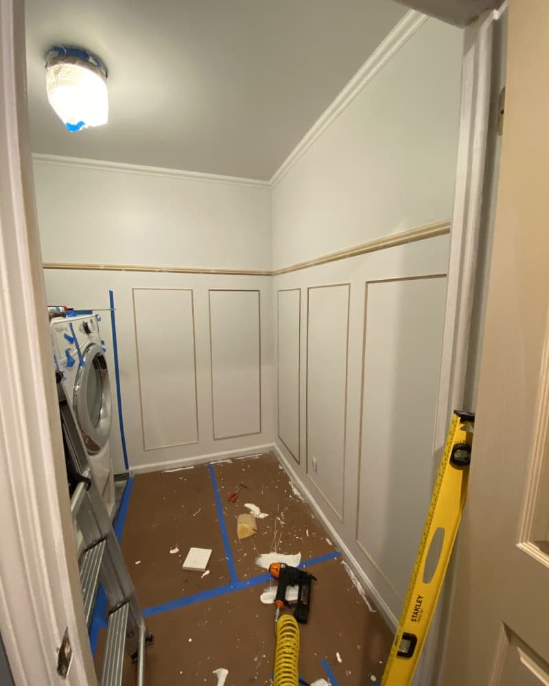 Mock up of wainscoting on bottom half of walls, tape on floor