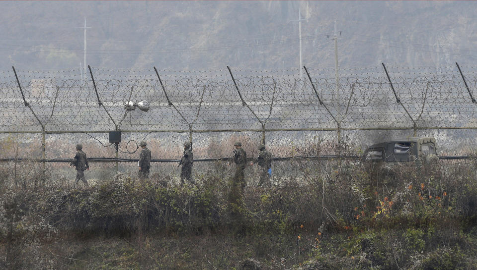 FILE - In this Nov. 16, 2018, file photo, South Korean army soldiers patrol along the barbed-wire fence in Paju, South Korea, near the border with North Korea. A North Korean diplomat who served as the country's acting ambassador to Kuwait has defected to South Korea, according to South Korean lawmakers who were briefed by Seoul's spy agency on Tuesday, Jan. 26, 2021. (AP Photo/Ahn Young-joon, File)