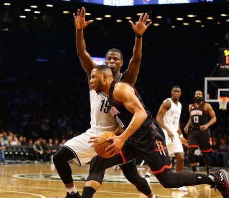 Jan 15, 2017; Brooklyn, NY, USA; Brooklyn Nets guard Isaiah Whitehead (15) defends against Houston Rockets guard Eric Gordon (10) while he dribbles the ball during the first half at Barclays Center. Mandatory Credit: Andy Marlin-USA TODAY Sports