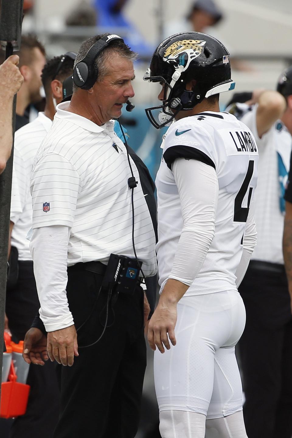 Former Jaguars head coach Urban Meyer (L) talks with kicker Josh Lambo after he missed a second field goal last September against the Denver Broncos. Lambo filed a lawsuit against the Jaguars Tuesday, seeking more than $3.5 million in salary and damages for emotional distress caused by Meyer kicking him before a preseason game against the Dallas Cowboys.