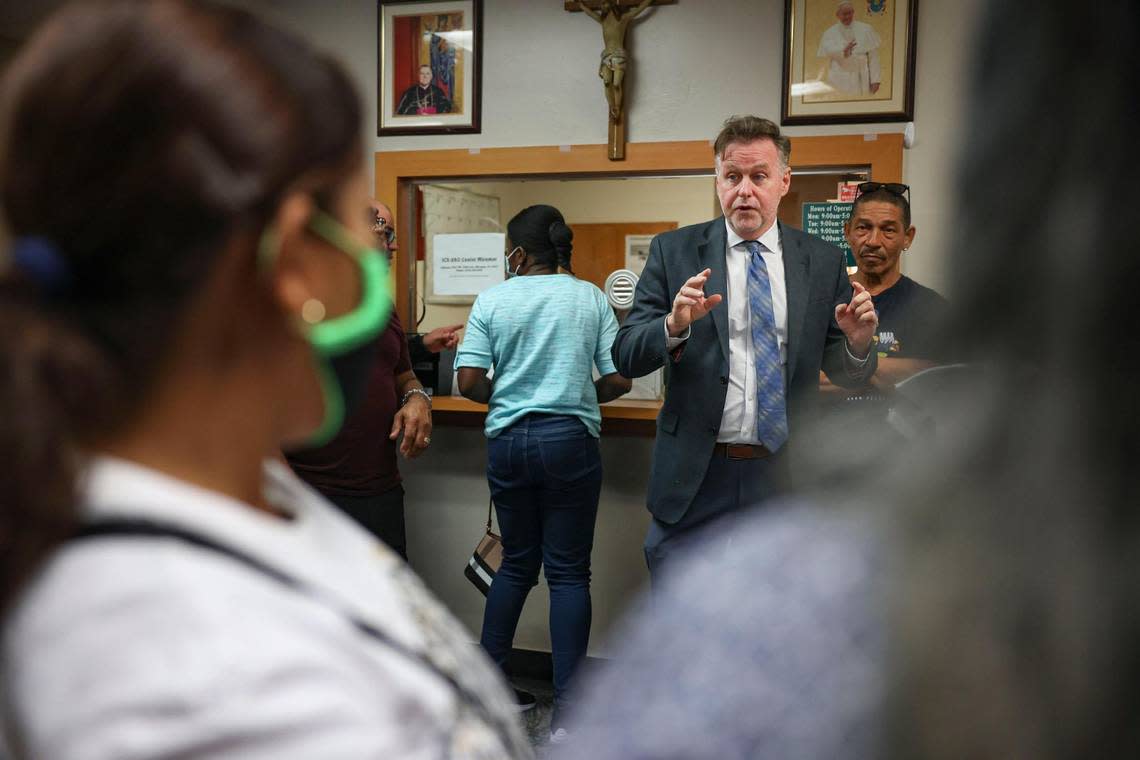 Randy McGrorty, co-founder of Catholic Legal Services, tries to organize 40 people waiting in the lobby, many of them migrants, inside Catholic Charities legal services on Monday, Jan. 9, 2023, in downtown Miami.