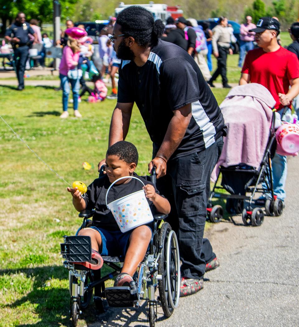 Chidlren gather Easter eggs equipped with a beeping sound to make them easier to find for the visually impaired during a blind and deaf accessible Easter egg hunt, hosted by the Alabama Institute for Deaf and Blind ,at Ida Bell Young Park in Montgomery, Ala., on Wednesday March 27, 2024.