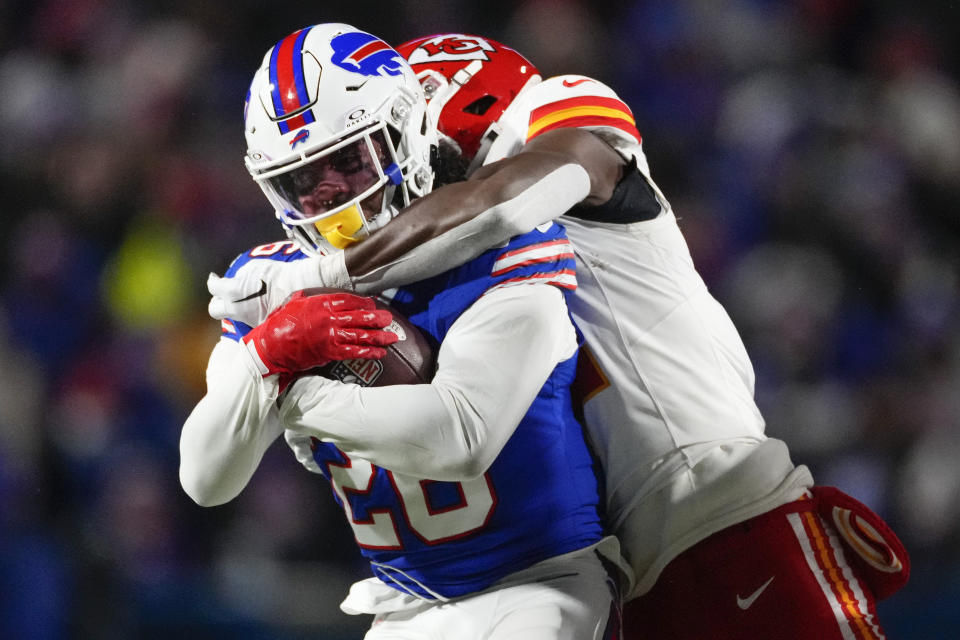 Buffalo Bills running back Ty Johnson (26) is tackled by the Kansas City Chiefs during the fourth quarter of an NFL AFC division playoff football game, Sunday, Jan. 21, 2024, in Orchard Park, N.Y. (AP Photo/Frank Franklin II)