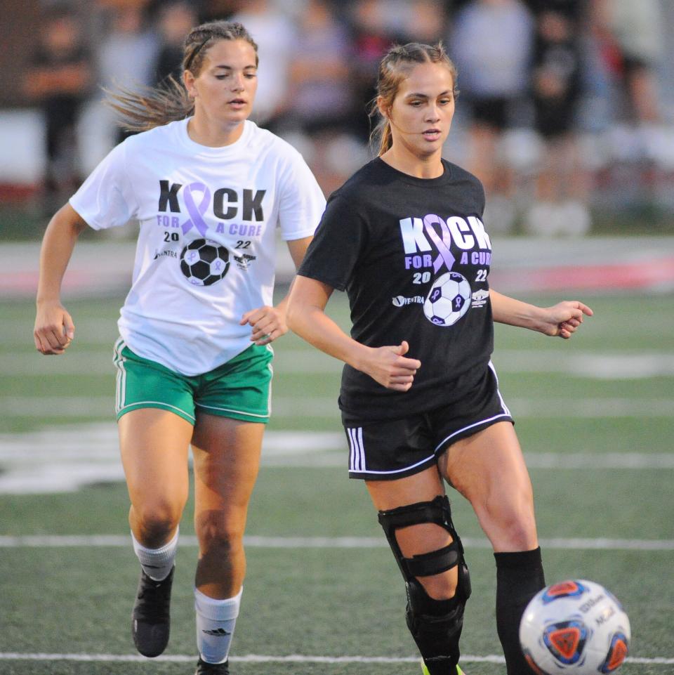 Salem's Abbie Davidson passes the ball to a teammate as West Branch's Kennedy Berger defends during an Eastern Buckeye Conference match at Sebo Stadium on Wednesday, October 5, 2022.