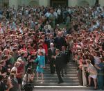 FILE - Former fellow Senators escort former Senate Majority Leader Bob Dole of Kan., and his wife Elizabeth as they leave Capitol Hill following Dole's official retirement from the Senate, June 11, 1996. Bob Dole, who overcame disabling war wounds to become a sharp-tongued Senate leader from Kansas, a Republican presidential candidate and then a symbol and celebrant of his dwindling generation of World War II veterans, has died. He was 98. His wife, Elizabeth Dole, posted the announcement Sunday, Dec. 5, 2021, on Twitter. (AP Photo/Ron Edmonds, File)