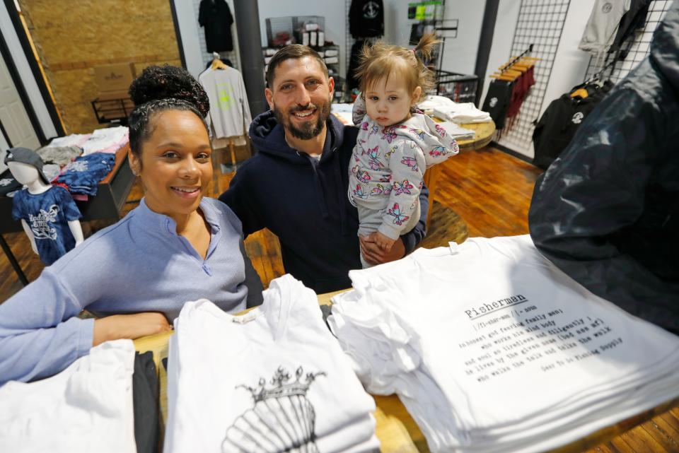 Anamaria Baptista, Peter Farland and their daughter, Ahriel Farland, 1, at the newly opened Gear to Go Fishing Supply at the Killburn Mill in New Bedford.