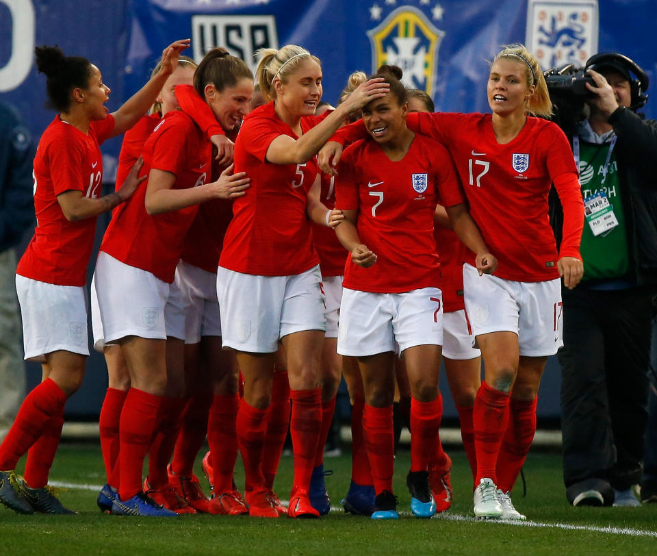 Nikita Parris is congratulated by teammates after scoring against USA.  (Photo by Frederick Breedon/Getty Images)