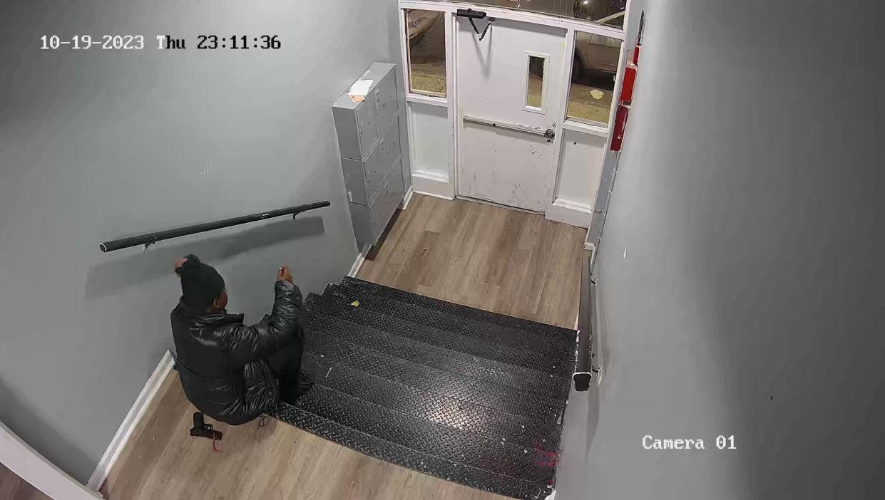 This photo showing a man with a gun was taken just before midnight on Thursday, Oct. 19, 2023 near the main entrance to the apartment building at 92 Carroll Street.