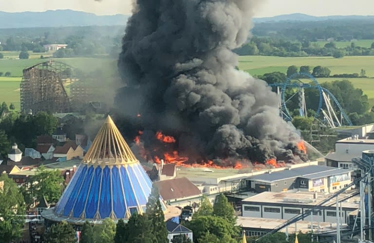 A black column of smoke rises from a warehouse in flames above Europa-park in Rust, southern Germany