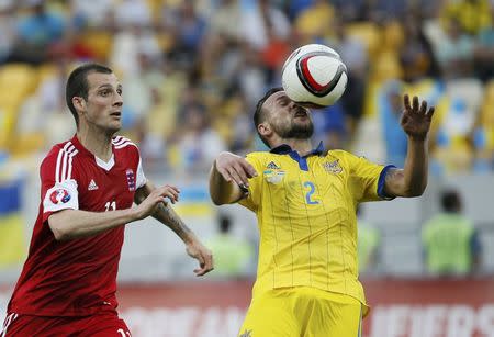 Luxembourg's Stefano Bensi (L) and Ukraine's Mykola Morozyuk fight for the ball during their Euro 2016 Group C qualifying soccer match at the Arena Lviv stadium in Lviv, Ukraine, June 14, 2015. REUTERS/Gleb Garanich