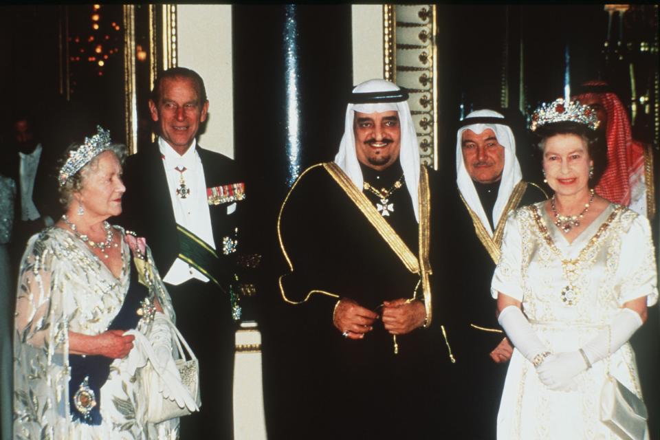 FILE - King Fahd of Saudi Arabia, center, poses with Queen Elizabeth II, right, Queen Elizabeth, Queen Mother and the Duke of Edinburgh, second left, as they go in to a banquet in the Kings's honour at Buckingham Palace, March 24, 1987. The Queen wears the chain of the Order of King Abdul Aziz in honour of the King. Not long after Queen Elizabeth II inherited her throne, large swaths of the world broke free from British control. Yet today after her death, British-installed monarchies still reign over millions across the Middle East. (AP-Photo/Peter Kemp/File)