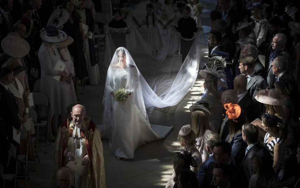 <p>Meghan walks down the aisle on her wedding day (Getty) </p>