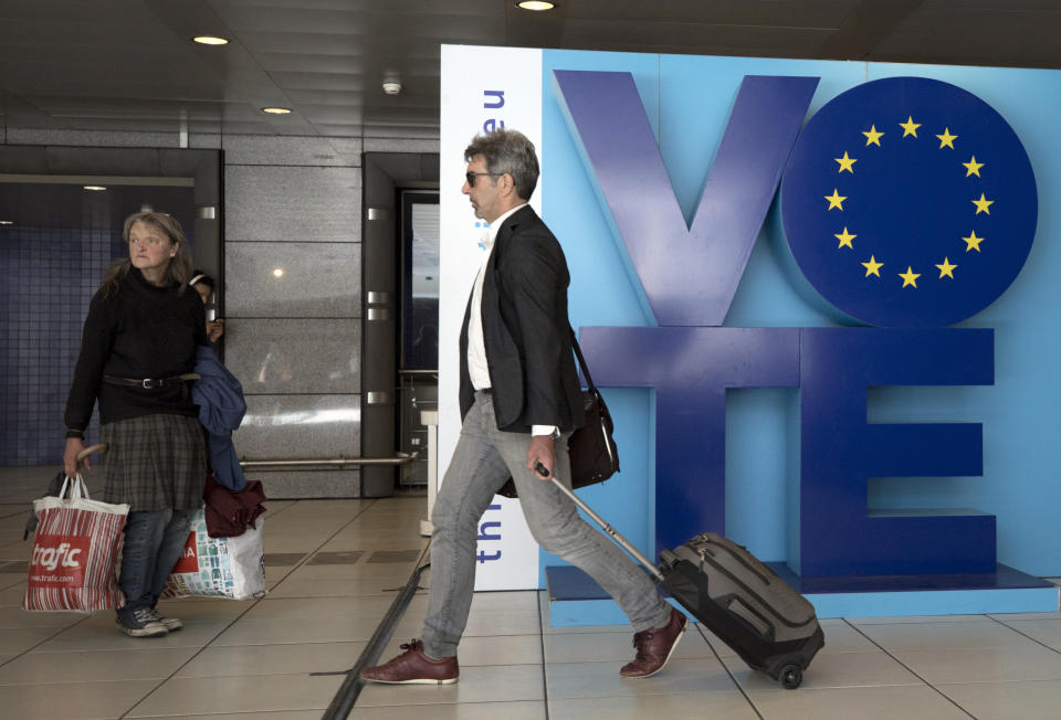 A man walks by an installation encouraging people to vote in the European elections at Luxembourg metro station in Brussels, Friday, May 24, 2019. Some 400 million Europeans from 28 countries will head to the polls May 23-26 to choose lawmakers to represent them at the European Parliament for the next five years. (AP Photo/Virginia Mayo)