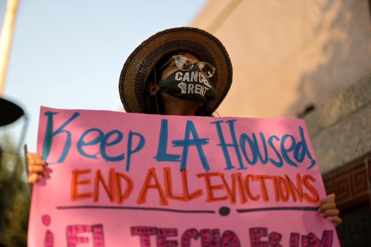 Protesters hold a sign saying: Keep LA Housed, End All Evictions.