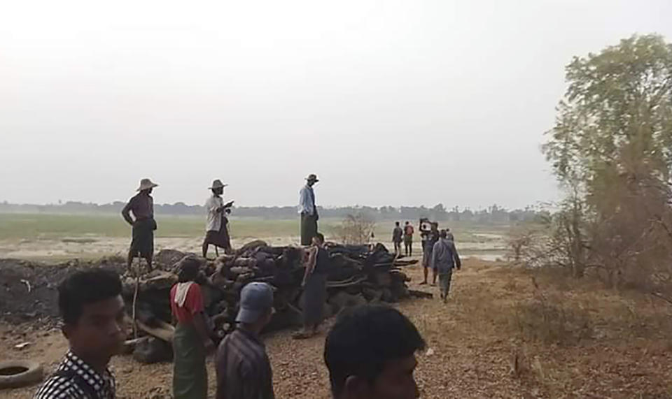 FILE - Men stand over a funeral pyre in Tar Taing village, as they prepare to cremate bodies of those found dead in the nearby village of Nyaung Yin, Myinmu township and in Tar Taing village, Sagaing township, central Myanmar on March 2, 2023. A group of human rights researchers officially launched a website Wednesday, Nov. 1, 2023 that they hope will help get justice for victims of state violence in Myanmar, where one of the world’s less-noticed but still brutal armed struggles is taking place. (UGC via AP, File)