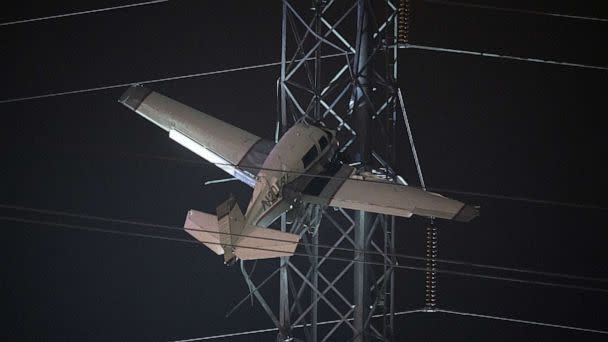 PHOTO: A small plane rests on live power lines after crashing, Sunday, Nov. 27, 2022, in Montgomery Village, a northern suburb of Gaithersburg, Md.  (AP Photo/Tom Brenner)