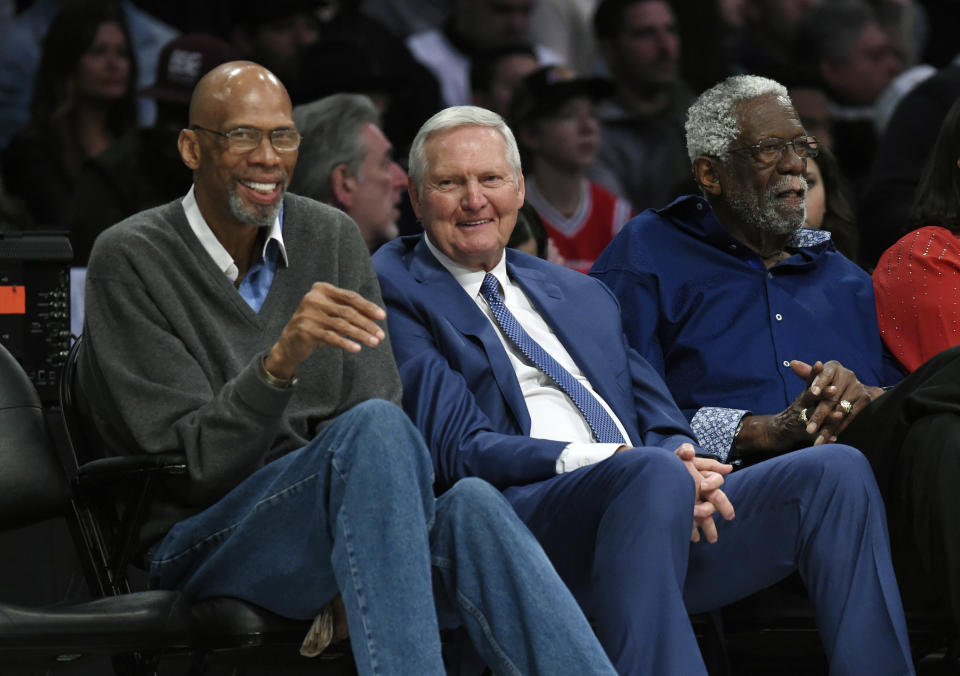 FILE – Former basketball players, left to right: Kareem Abdul-Jabbar, Jerry West and Bill Russell watch during the first half of an NBA All-Star basketball game, Sunday, Feb. 18, 2018, in Los Angeles.  Jerry West, who was selected to the Basketball Hall of Fame three times in a storied career as a player and executive and whose silhouette is considered the foundation of the NBA logo, died Wednesday morning, June 12, 2024, the Los Angeles Clippers announced.  He was 86. (AP Photo/Chris Pizzello, File)