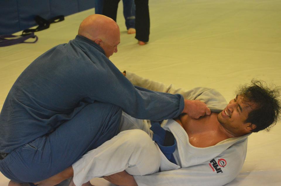 Grappling student Isaia Faumui, 32, and 40-year-old Travis Nicolay clinch each other's gi during a class at Rice Brothers Brazilian Jiu-jitsu in Redding on Monday, April 27, 2020.