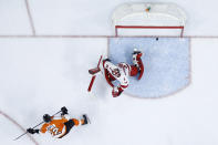 Philadelphia Flyers' Michael Raffl, left, scores a goal against Carolina Hurricanes' Alex Nedeljkovic during the second period of an NHL hockey game, Thursday, March 5, 2020, in Philadelphia. (AP Photo/Matt Slocum)