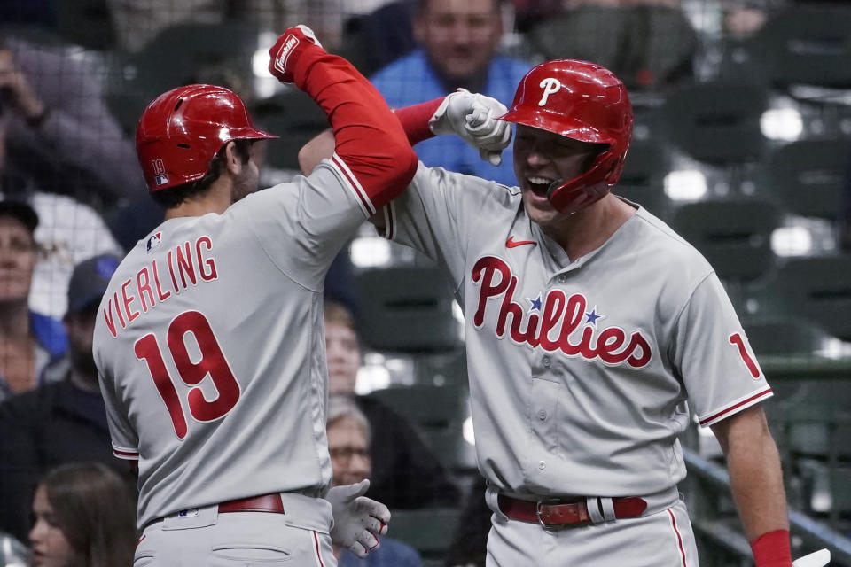 Philadelphia Phillies' Matt Vierling (19) is congratulated by Rhys Hoskins after hitting a go-ahead home run during the ninth inning of the team's baseball game against the Milwaukee Brewers on Tuesday, June 7, 2022, in Milwaukee. (AP Photo/Aaron Gash)