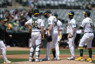 Oakland Athletics pitcher Ross Stripling (36) waits for manager Mark Kotsay, left, before being pulled during the second inning of a baseball game against the Texas Rangers, Tuesday, May 7, 2024, in Oakland, Calif. (AP Photo/Godofredo A. Vásquez)