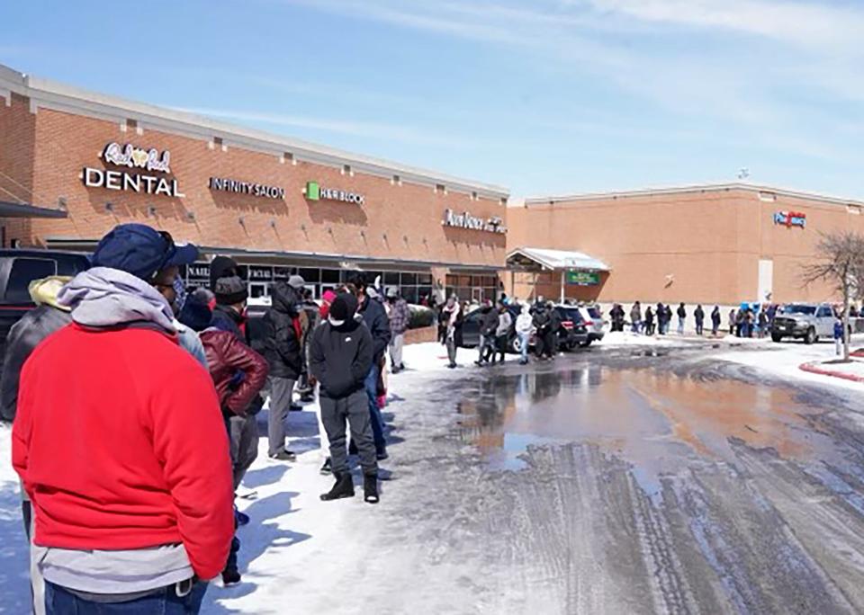 People wait in line at a mall to get inside an H-E-B supermarket in Round Rock, Texas, on February 16, 2021