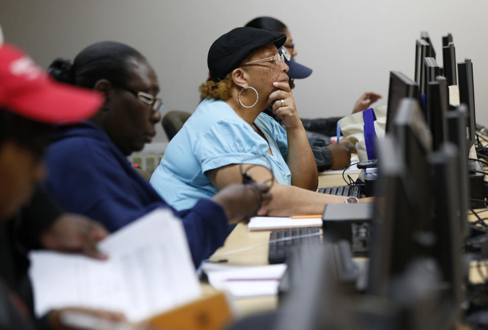 This photo taken March 12, 2014, shows student Sharron Foreman, center, working on a computer alongside classmates during a remedial mathematics course at Baltimore City Community College in Baltimore. Only about a quarter of students nationally who take developmental _ or remedial _ classes ever graduate. The problem is so profound that the advocacy group Complete College America dubs remedial classes the “bridge to nowhere.” The challenge, educators say, is that even as billions is spent annually on remedial classes, many of these students run out of financial aid before they can complete their credit requirements, get discouraged by non-credit classes or find themselves unable to complete them. The Baltimore school is one of several places around the country looking to improve the odds for these students. (AP Photo/Patrick Semansky)