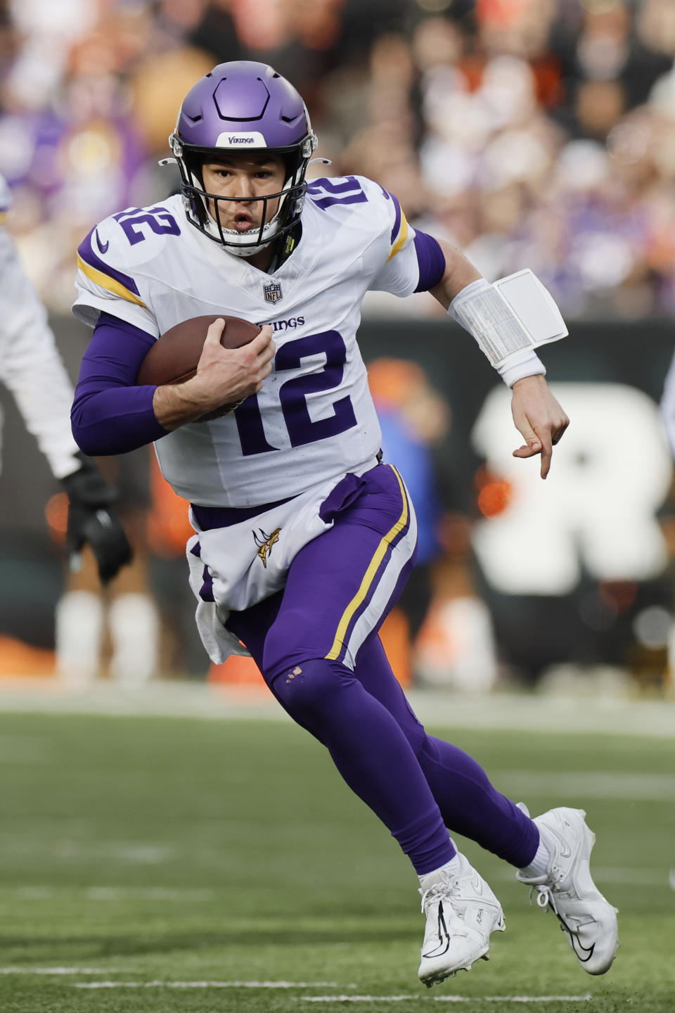 Minnesota Vikings quarterback Nick Mullens (12) runs against the Cincinnati Bengals during the first half of an NFL football game Saturday, Dec. 16, 2023, in Cincinnati. (AP Photo/Jay LaPrete)