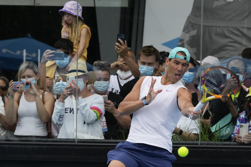 Rafael Nadal of Spain is watched by fans during a practice session at Melbourne Park at the Australian Open tennis championships in Melbourne, Australia, Saturday, Jan. 29, 2022. Nadal will play Russia's Daniil Medvedev on Sunday Jan. 30 in the men's singles final. (AP Photo/Mark Baker)