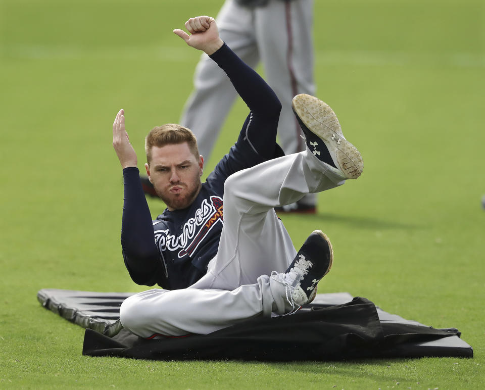 Atlanta Braves first baseman Freddie Freeman practices his sliding technique using the new sliding matts on the team's agility field during spring training on Friday, Feb. 21, 2020, in North Port, Fla. (Curtis Compton/Atlanta Journal-Constitution via AP)