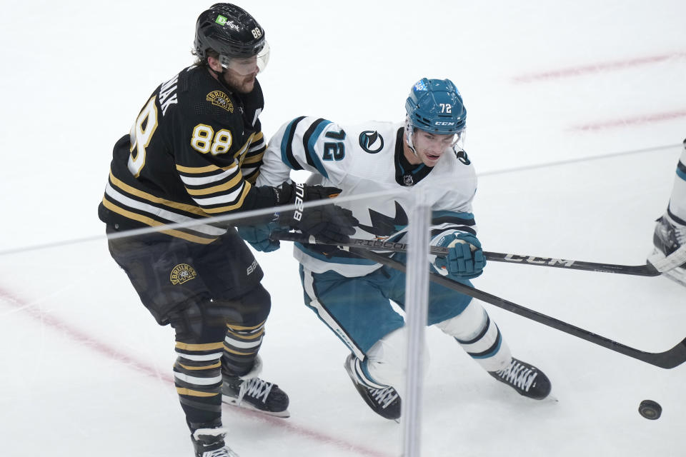 Boston Bruins right wing David Pastrnak (88) and San Jose Sharks center William Eklund pursue the puck in the first period of an NHL hockey game, Thursday, Nov. 30, 2023, in Boston. (AP Photo/Steven Senne)