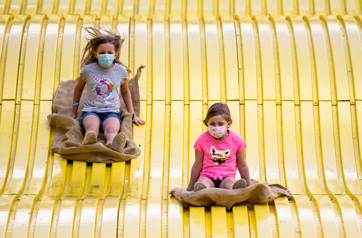 Lili Wallman, 7, center, heads down the Giant Slide with her sister Essa Wallman, 9, left, during the 2021 Illinois State Fair at the Illinois State Fairgrounds in Springfield, Ill., Monday, August 16, 2021. [Justin L. Fowler/The State Journal-Register]