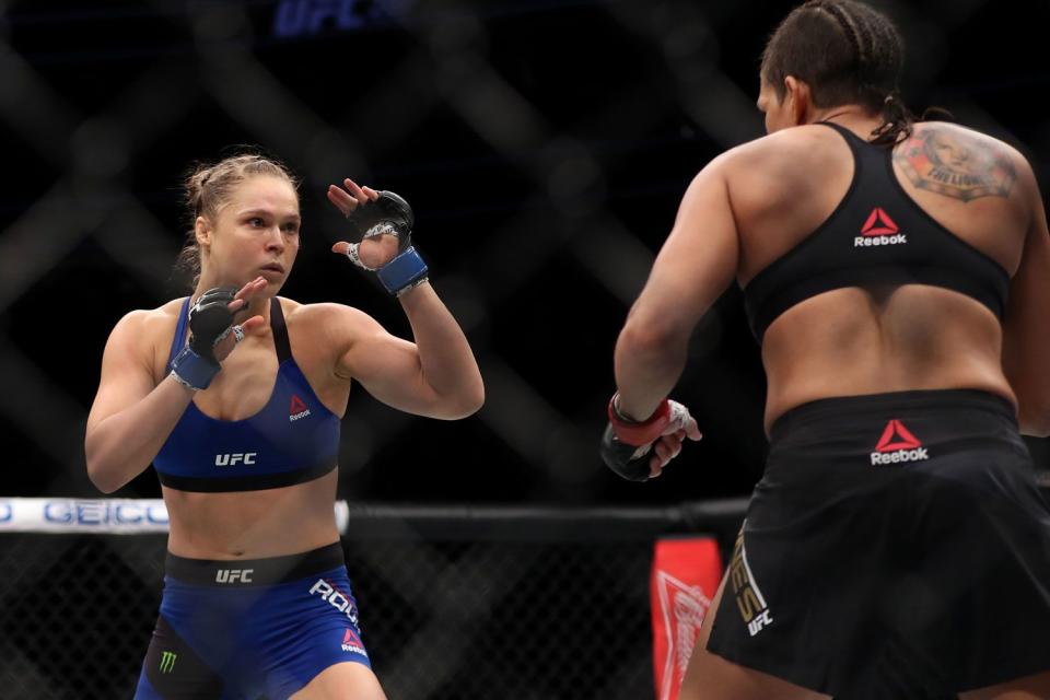 <p>Christian Petersen/Getty</p> Ronda Rousey fighting Amanda Nunes