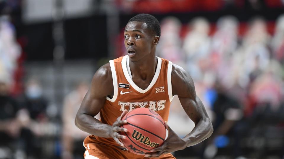 Texas' Andrew Jones (1) controls the ball during the second half of an NCAA college basketball game against Texas Tech in Lubbock, Texas, Saturday, Feb. 27, 2021. (AP Photo/Justin Rex)