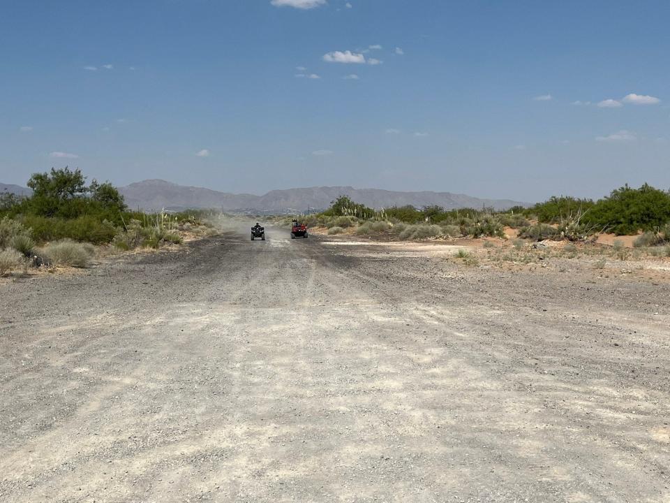 Sunland Park Fire Department rescue crews ride all-terrain vehicles to reach a body found in the desert off Highway 9 near Santa Teresa, New Mexico, on Saturday.