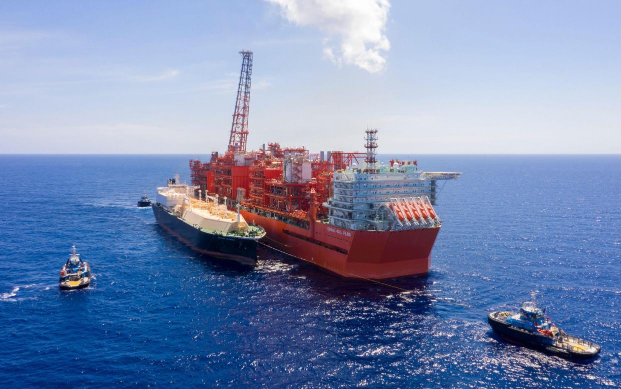 A tanker loads liquefied natural gas alongside a floating platform off the coast of Mozambique