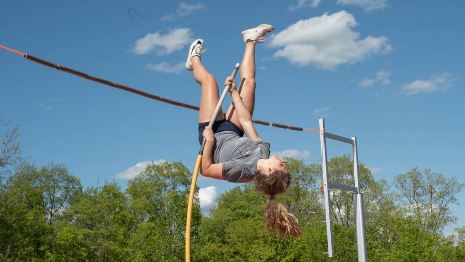 New Richmond junior Samantha Ringhand propels herself into the air and vaults over a bungee cord at practice before the Southern Buckeye Academic and Athletic Conference league meet.