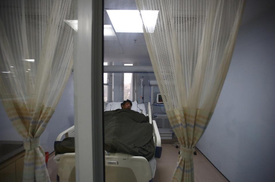 Tashi Sherpa lies on the bed of the Intensive Care Unit at Grandi International Hospital after he was rescued and airlifted from the avalanche site at Mount Everest in Kathmandu