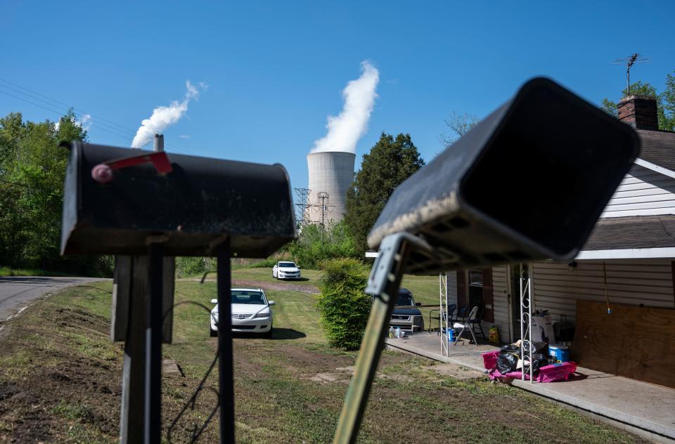 Cars are parked in front of a home as steam rises from the Miller coal Power Plant in Adamsville, Alabama on April 11, 2021. - The James H. Miller Jr. site faces no immediate shutdown threat and has the backing of many locals because of the jobs it offers -- despite sending about as much planet warming carbon dioxide into the sky last year as 3.7 million cars. The plant highlights a key problem in counteracting climate change -- even for people who have accepted it is happening, the threat can be overshadowed by pressing daily needs like paying bills. That ongoing battle will bring together world leaders this week in Washington as President Joe Biden works to revitalize a global effort left in chaos by his predecessor Donald Trump. (Photo by ANDREW CABALLERO-REYNOLDS / AFP) (Photo by ANDREW CABALLERO-REYNOLDS/AFP via Getty Images)