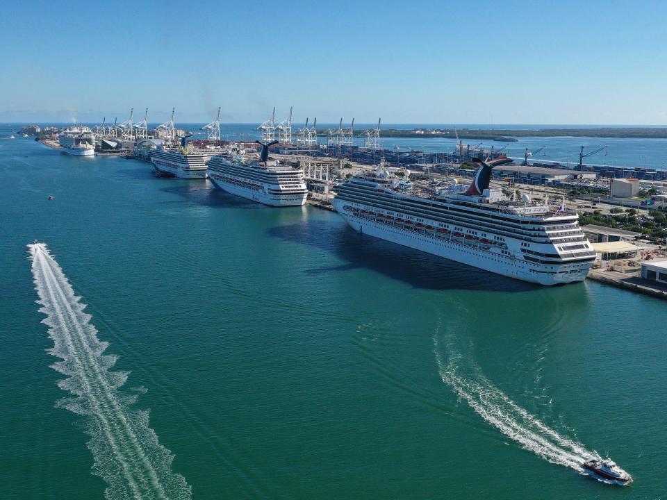 Cruise ships wait for people to embark before leaving Port of Miami on December 31, 2021 in Miami, Florida.