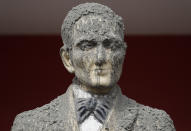 In this Wednesday, Jan. 15, 2020, photo, A statue of Philippine national hero Jose Rizal is covered in volcanic ash in Talisay, Batangas province, southern Philippines. Taal volcano is spewing lava into the sky and trembled constantly, possibly portending a bigger and more dangerous eruption, as tens of thousands of people fled villages darkened and blanketed by heavy ash. (AP Photo/Aaron Favila)