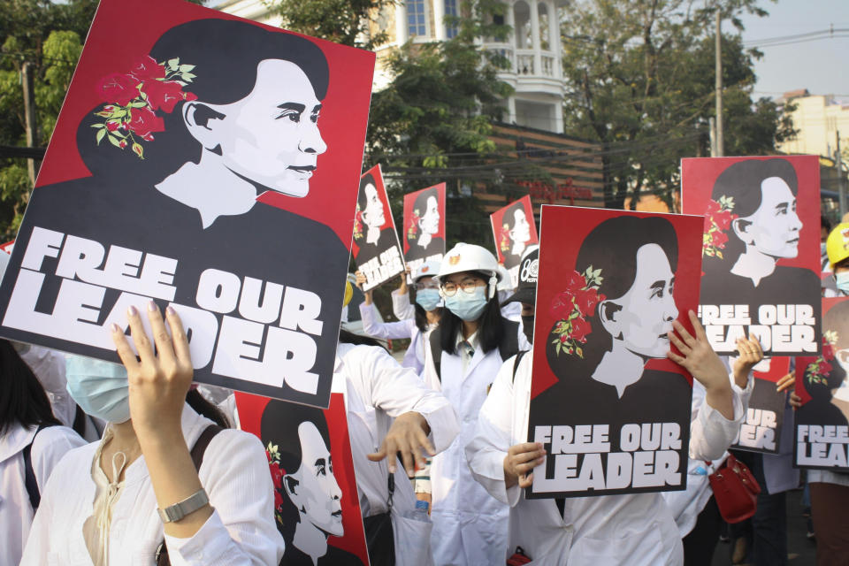 FILE - Medicals students display images of deposed Myanmar leader Aung San Suu Kyi during a street march in Yangon, Myanmar, on Feb. 28, 2021. A Myanmar court convicted Suu Kyi in more corruption cases Monday, Aug. 15, 2022, adding six years to prison sentence. (AP Photo, File)