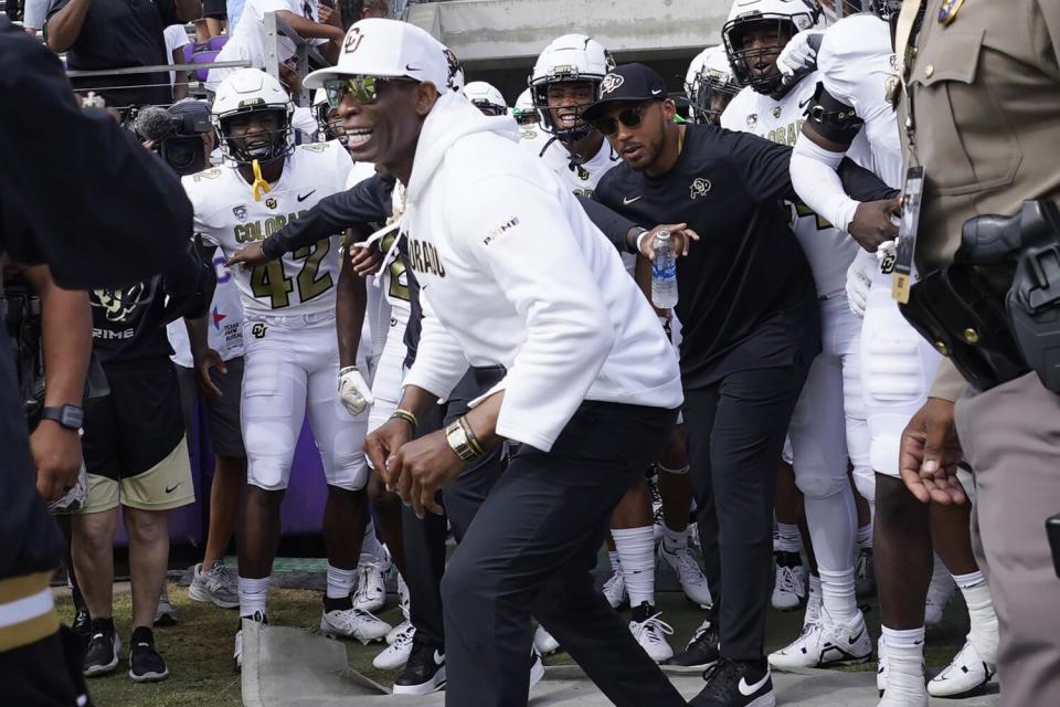 Colorado coach Deion Sanders fires up his team before running onto the field with his team