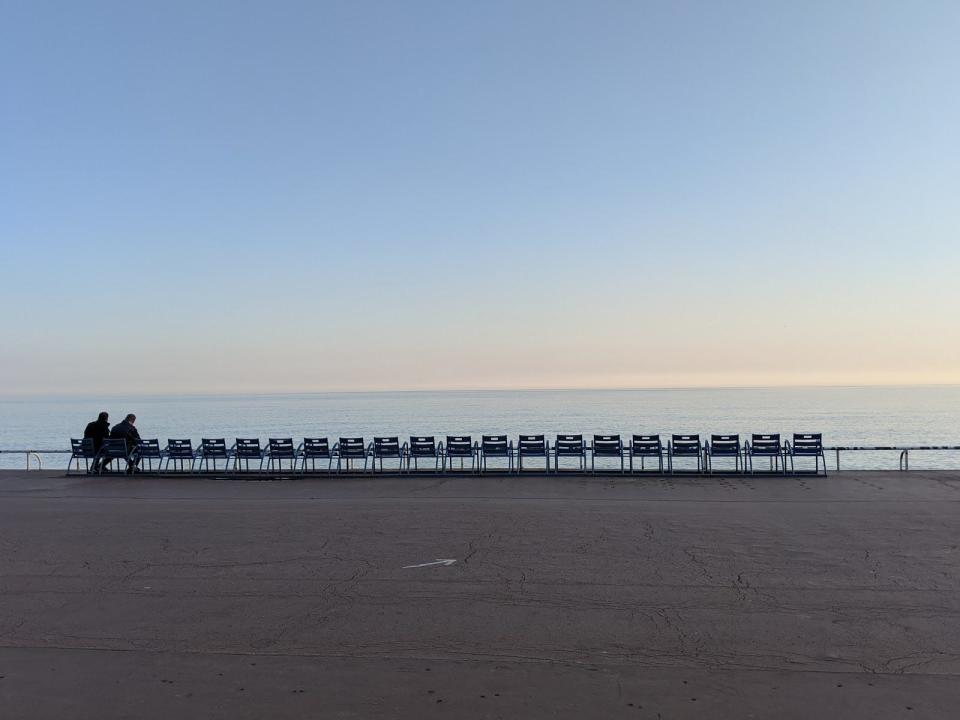 A couple defies social distancing rules on the Promenade des Anglais in Nice, France, during the early days of the coronavirus lockdown.