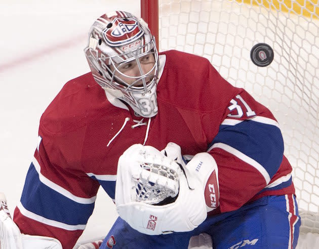 Montreal Canadiens goalie Carey Price keeps his eyes on the puck during the third period of the team's NHL hockey game against the Vancouver Canucks on Wednesday, Nov. 2, 2016, in Montreal. (Ryan Remiorz/The Canadian Press via AP)