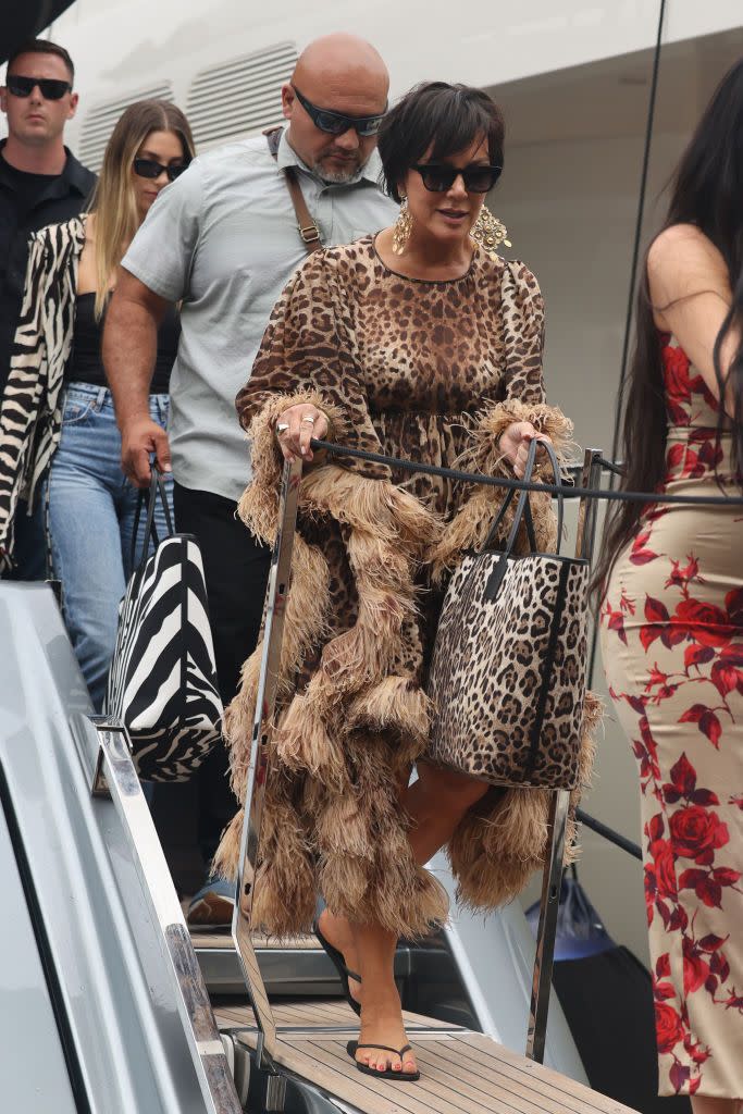 <p>Kris stepped aboard the boat to the Abbey of San Fruttuoso in flip flops, a leopard print tote bag, dangly earrings and a voluminous leopard print dress with textured fringing.</p>