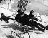 <p>The Beatles – Paul McCartney (front), John Lennon (middle), George Harrison (back), and Ringo Starr (fallen off the back) – partake in a little snow sledding, Austria, 1965.</p>