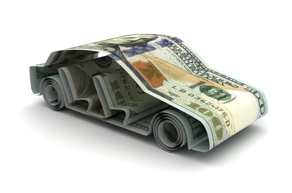 Multiple hundred dollar bills molded into the shape of a car.